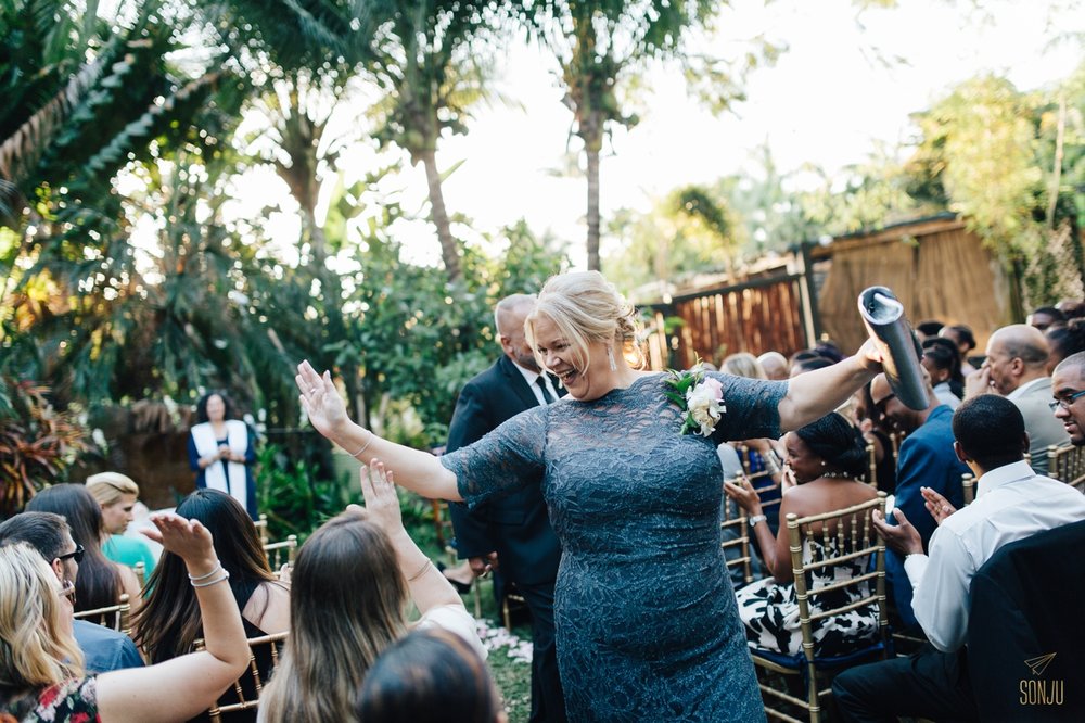 Mom high fives guests down the aisle