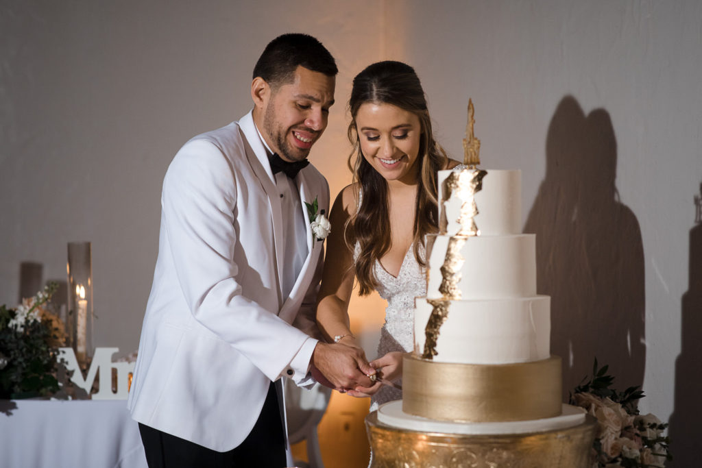 Bride and groom cut the cake at their wedding reception at the Coral Gables Country Club