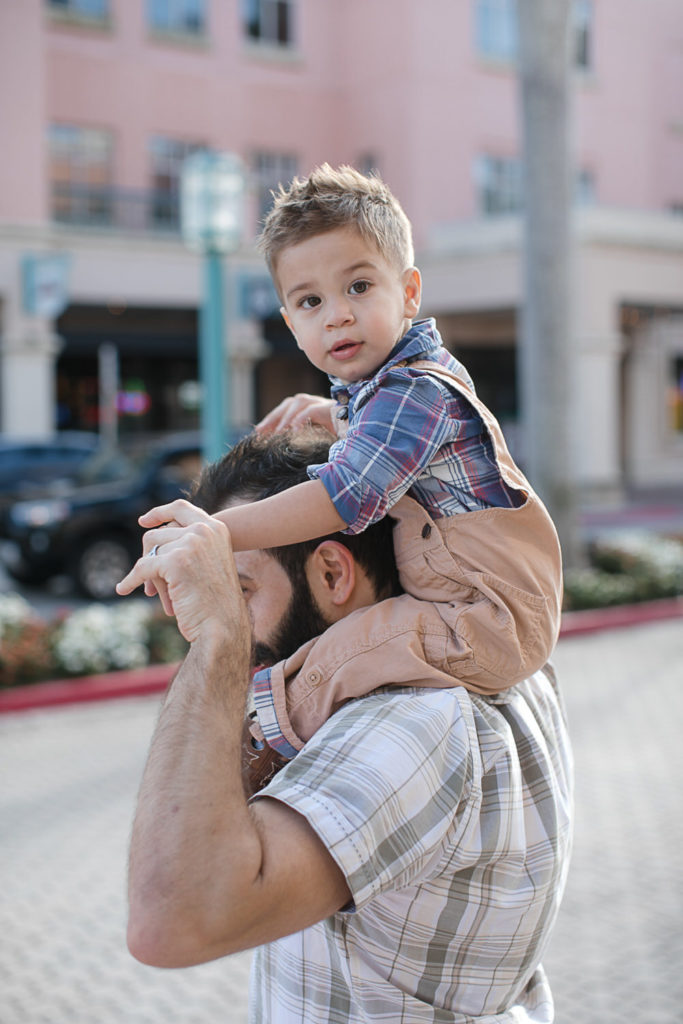 Photo of toddler boy on dads shoulder at Mizner Park in Boca Raton 