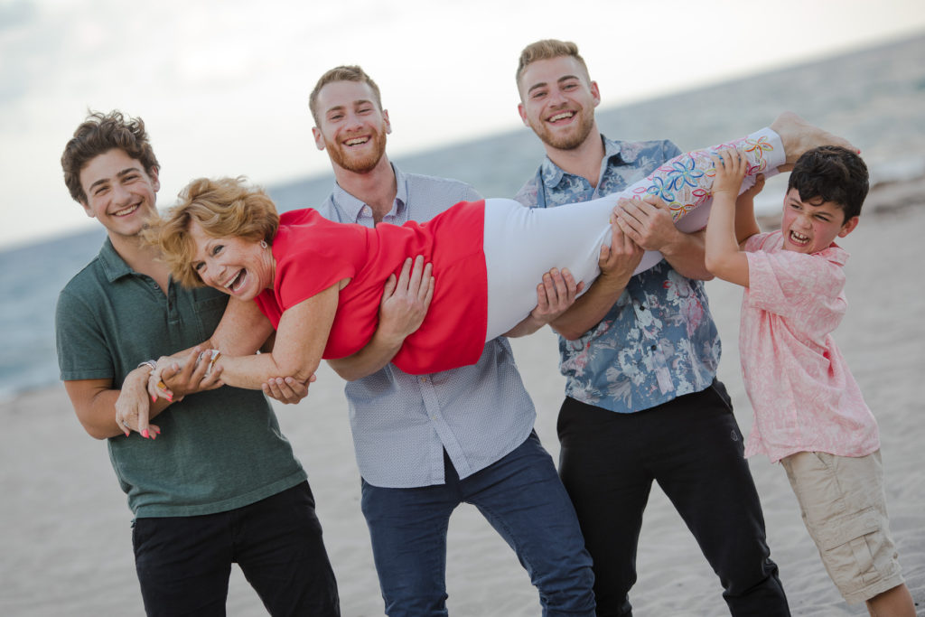Grandma is lifted by her grandsons during an extended family session in Palm Beach Florida 