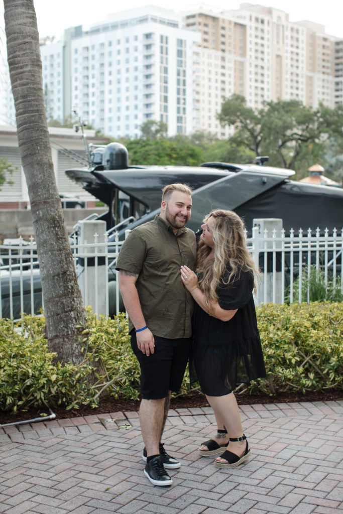 Newly engaged couple posing in the courtyard of the Riverside hotel during a proposal session 