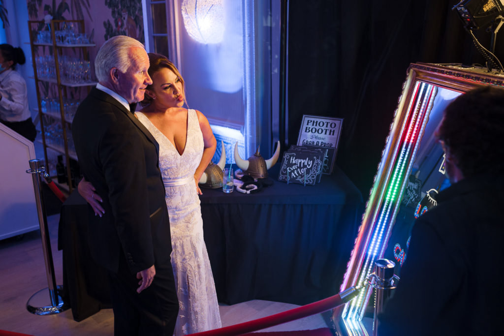 Bride and groom enjoy a mirror photo booth at the Colony Palm Beach