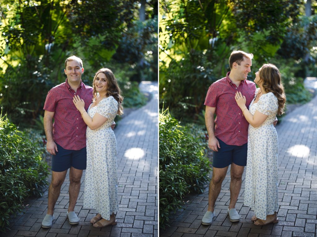 Engaged couple poses for a camera-aware portrait near the entrance of Fairchild Tropical Gardens in Miami, Florida