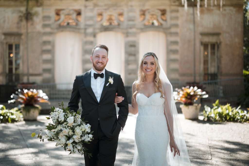 Bride and Groom pose on the mound at Vizcaya Museum and Gardens before their wedding ceremony
