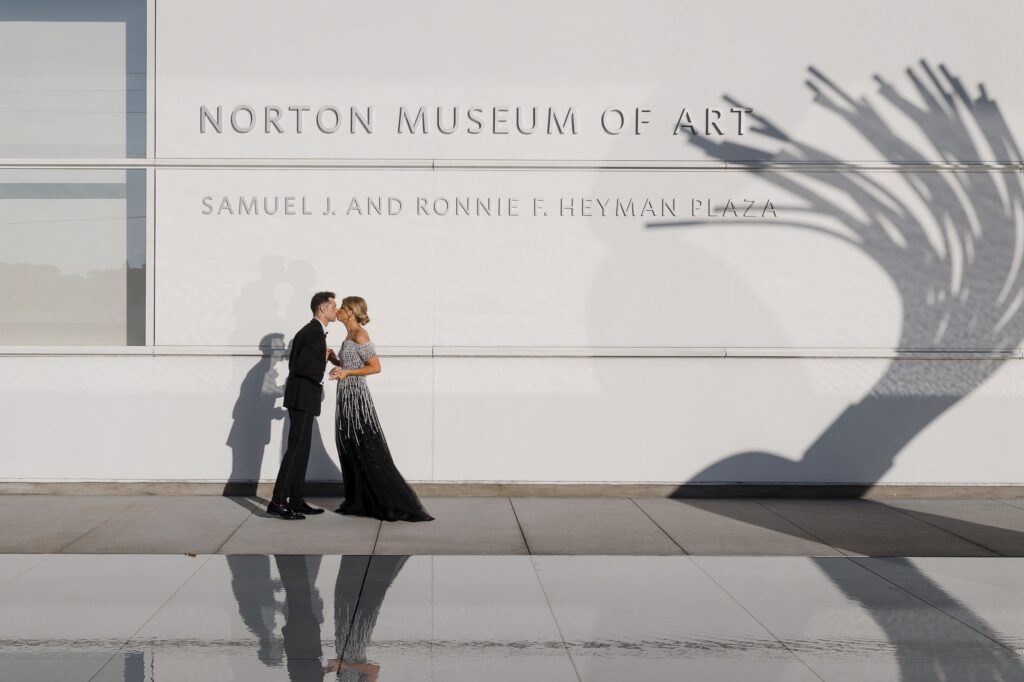 Wedding couple poses at the reflection pool at the Norton Museum of Art